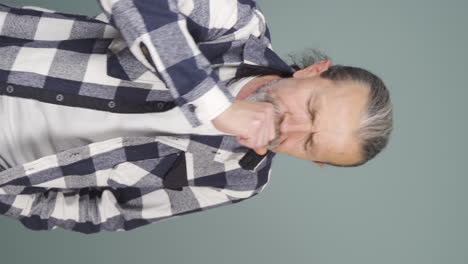 Vertical-video-of-Sick-old-man-coughing.